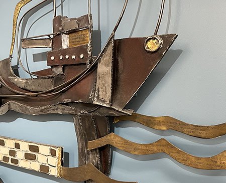 Abstract metal ship art piece engraved with names